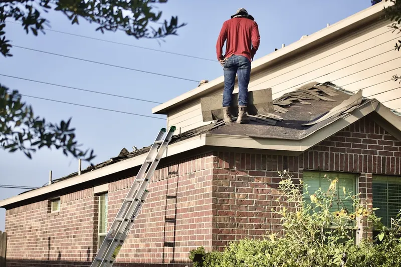 Professional roofer working on a residential roof in Northeast Meridian